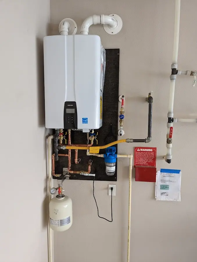 Professional plumber installing copper piping in a Cresskill home